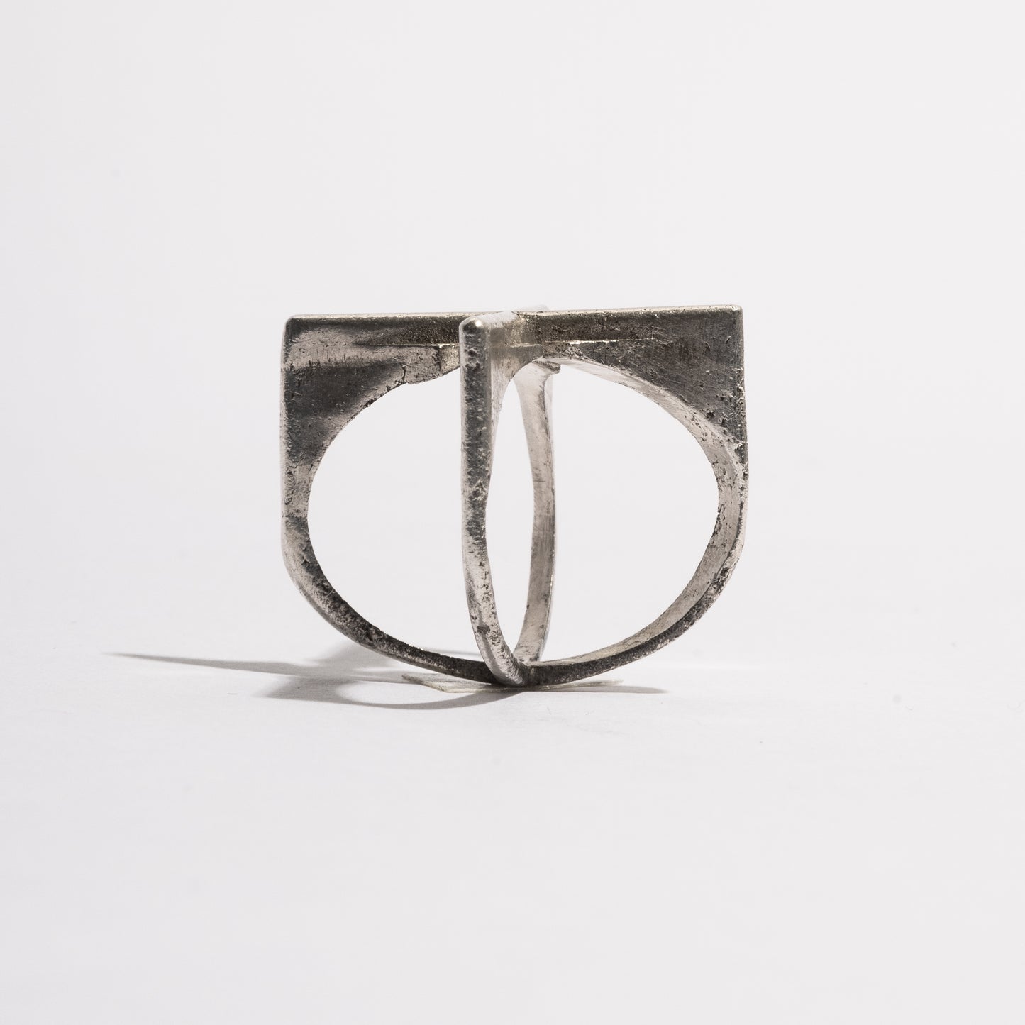 Side view of the Cross Ring by Sebamakes, sterling silver ring with bold intersecting lines and a minimal architectural structure handcrafted in Italy.