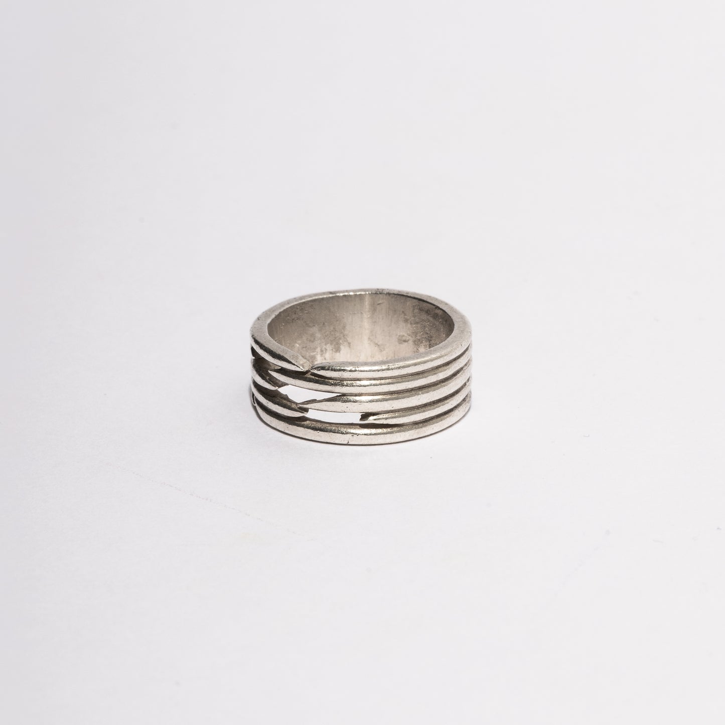 Angled detail of the Puncture Ring in sterling silver by Sebamakes, featuring handcrafted texture and precise geometric hollow design.