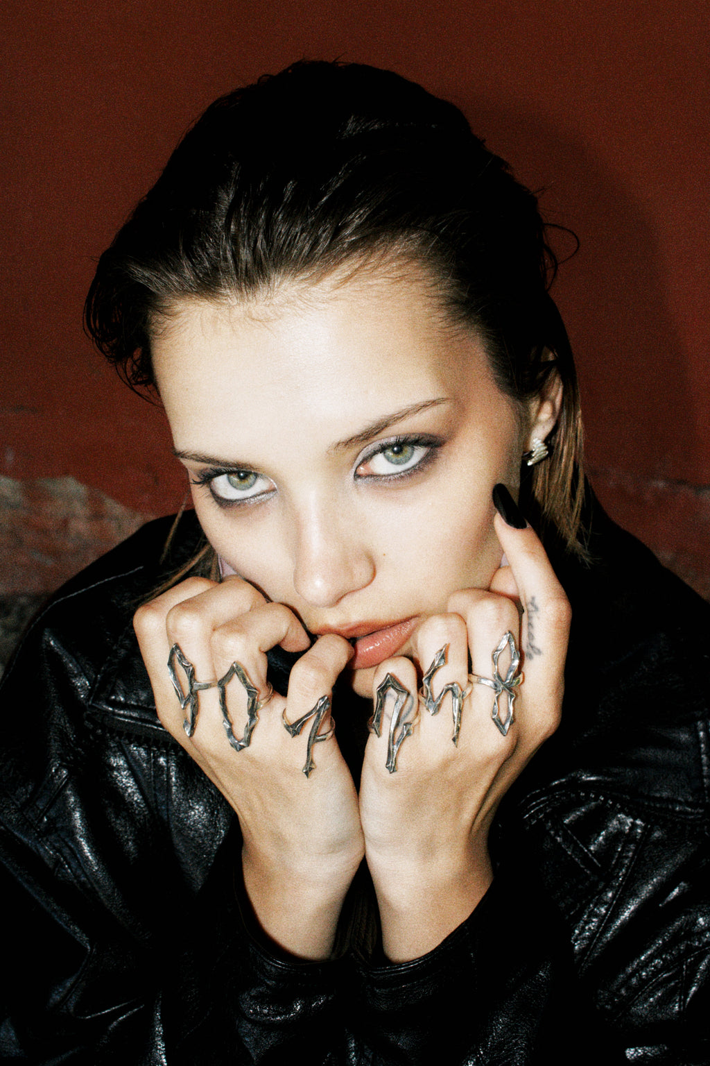 Model wearing multiple silver number rings from the 09 Collection by Seba Makes, showcasing how the pieces can be styled and worn together.