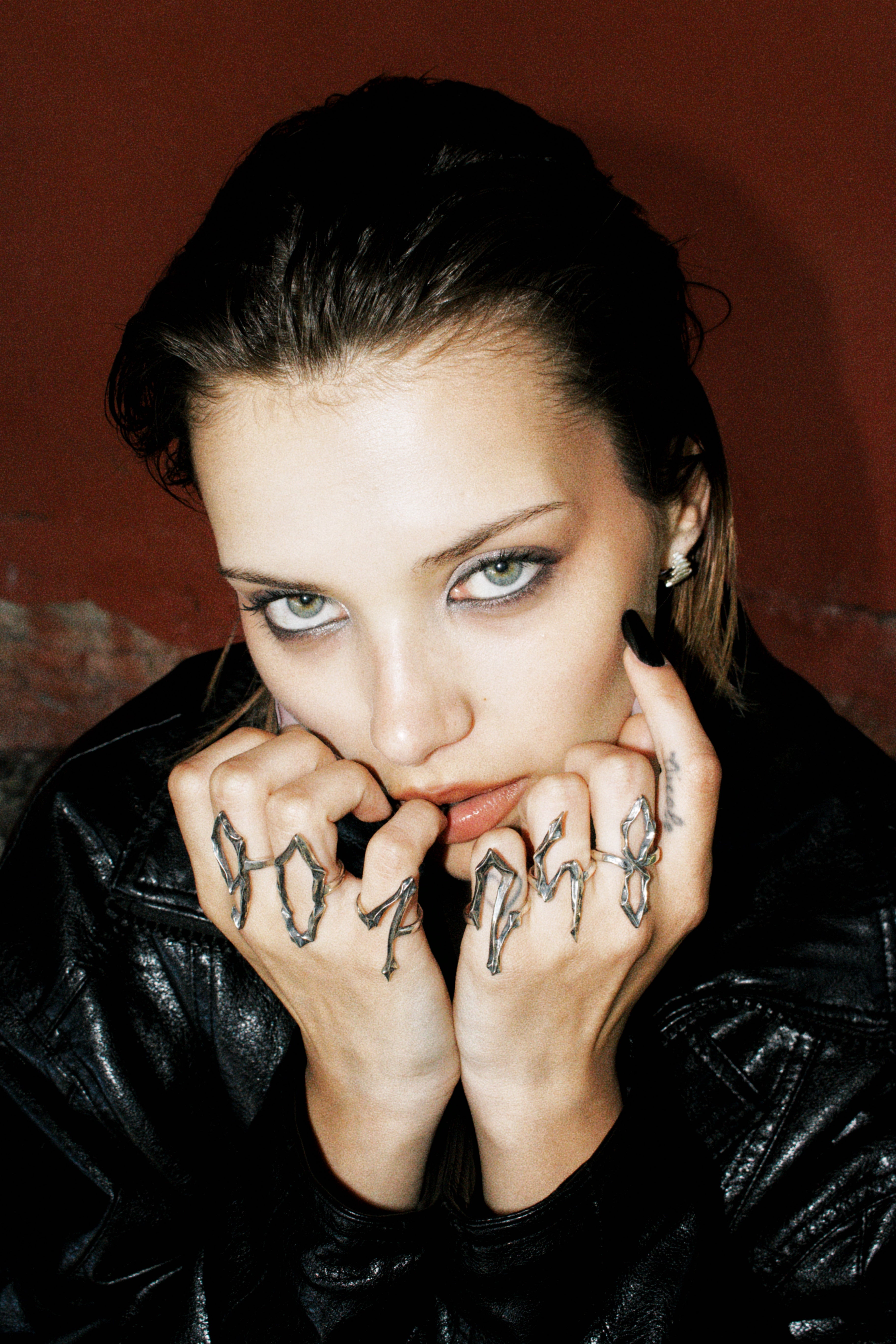 Model wearing multiple silver number rings from the 09 Collection by Seba Makes, showcasing how the pieces can be styled and worn together.