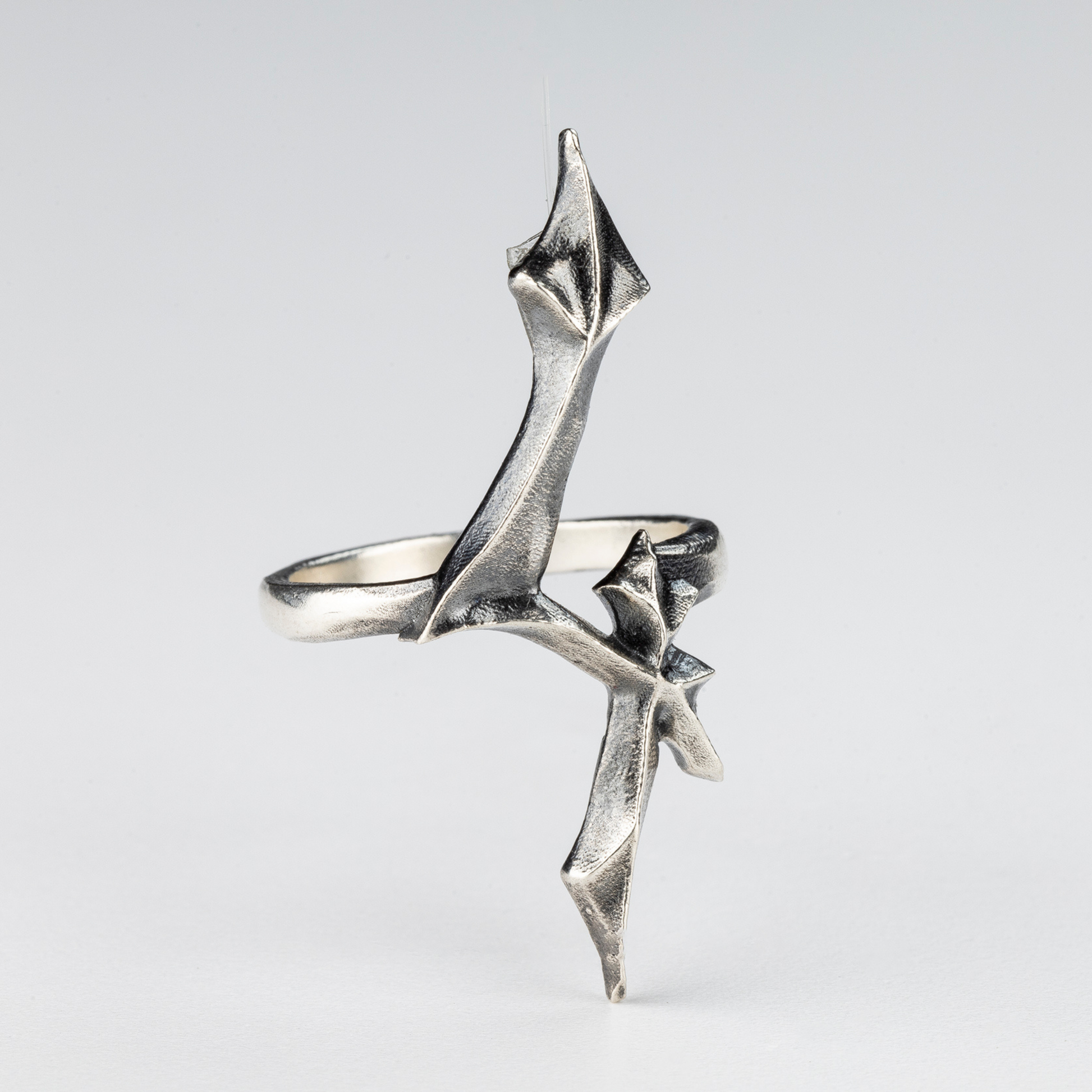 Detailed close-up of the 4 Ring showing sculpted gothic lines in sterling silver