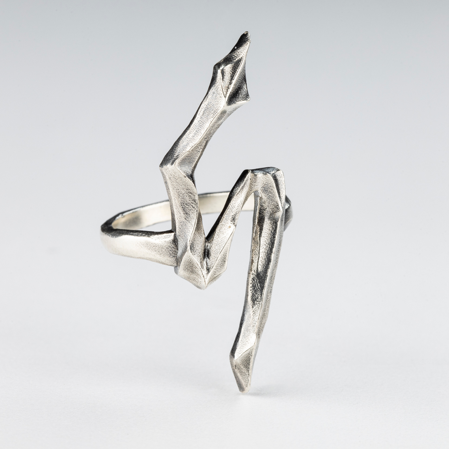 Gothic sculptural silver 5 ring photographed from a side angle – handcrafted by Sebamakes.