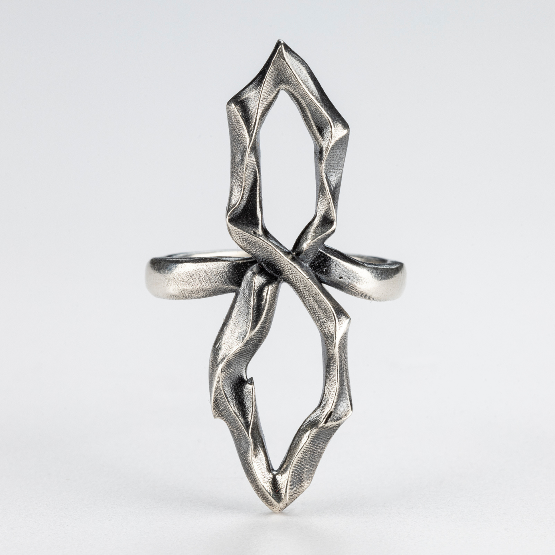Handcrafted gothic silver 8 ring — front view with sculptural open structure.
