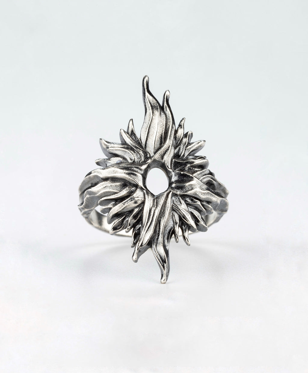 Front view of the Dusk Sun silver ring by Sebamakes, featuring radiating textured details extending from the center