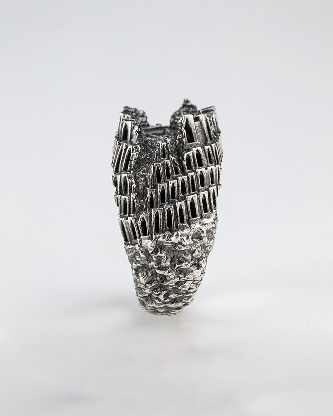 Vertical silhouette of Babel Ring, architectural handmade jewelry with layered structure inspired by Tower of Babel myth.