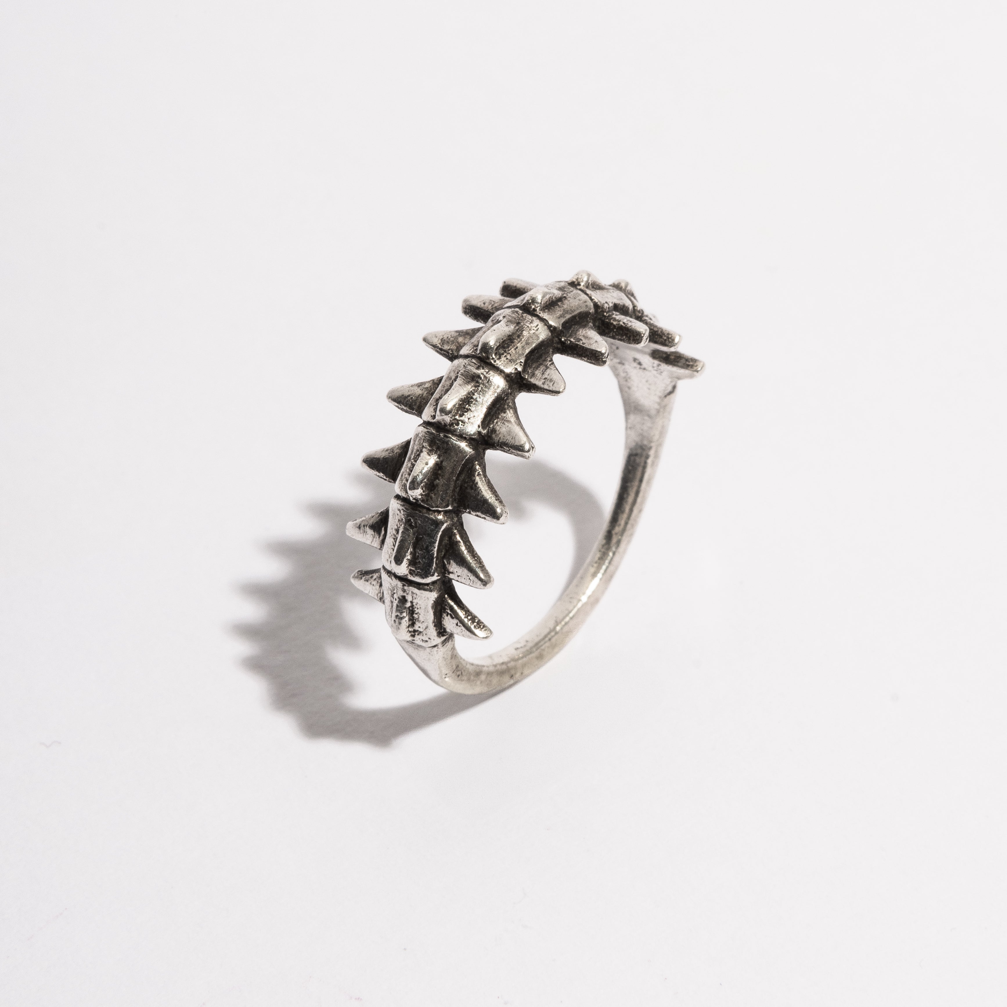 Angled view of the Backbone Ring by Sebamakes, handcrafted sterling silver ring inspired by human spine structure, made in Italy.