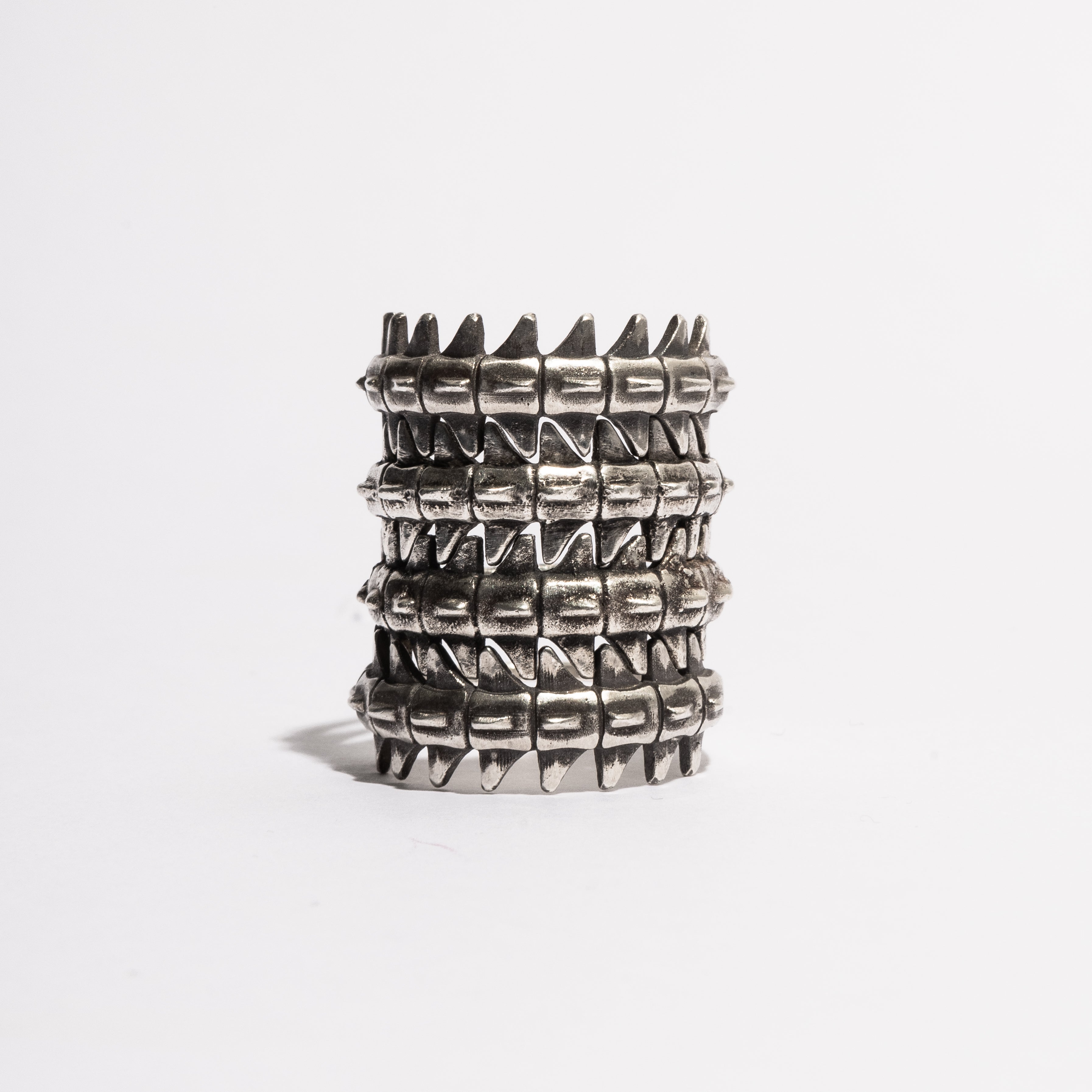 Stacked view of multiple Backbone Rings by Sebamakes, handcrafted sterling silver rings with anatomical spine-inspired design.