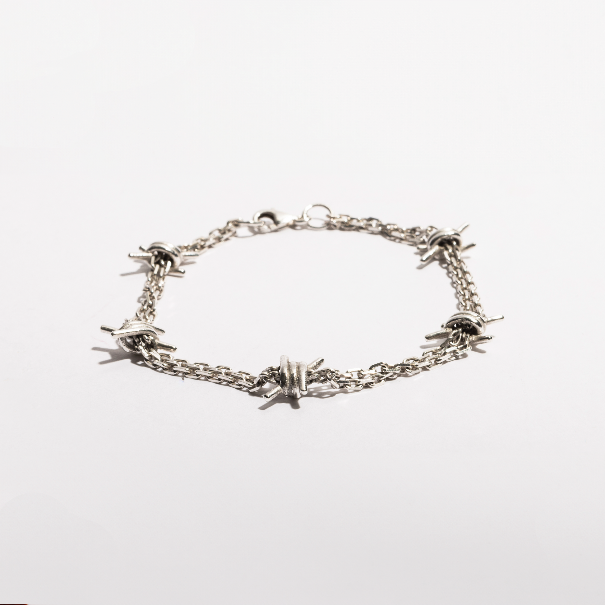 Angled view of the Barbwire Bracelet by Sebamakes, handcrafted in sterling silver with sharp barbed details and an artisanal industrial aesthetic.