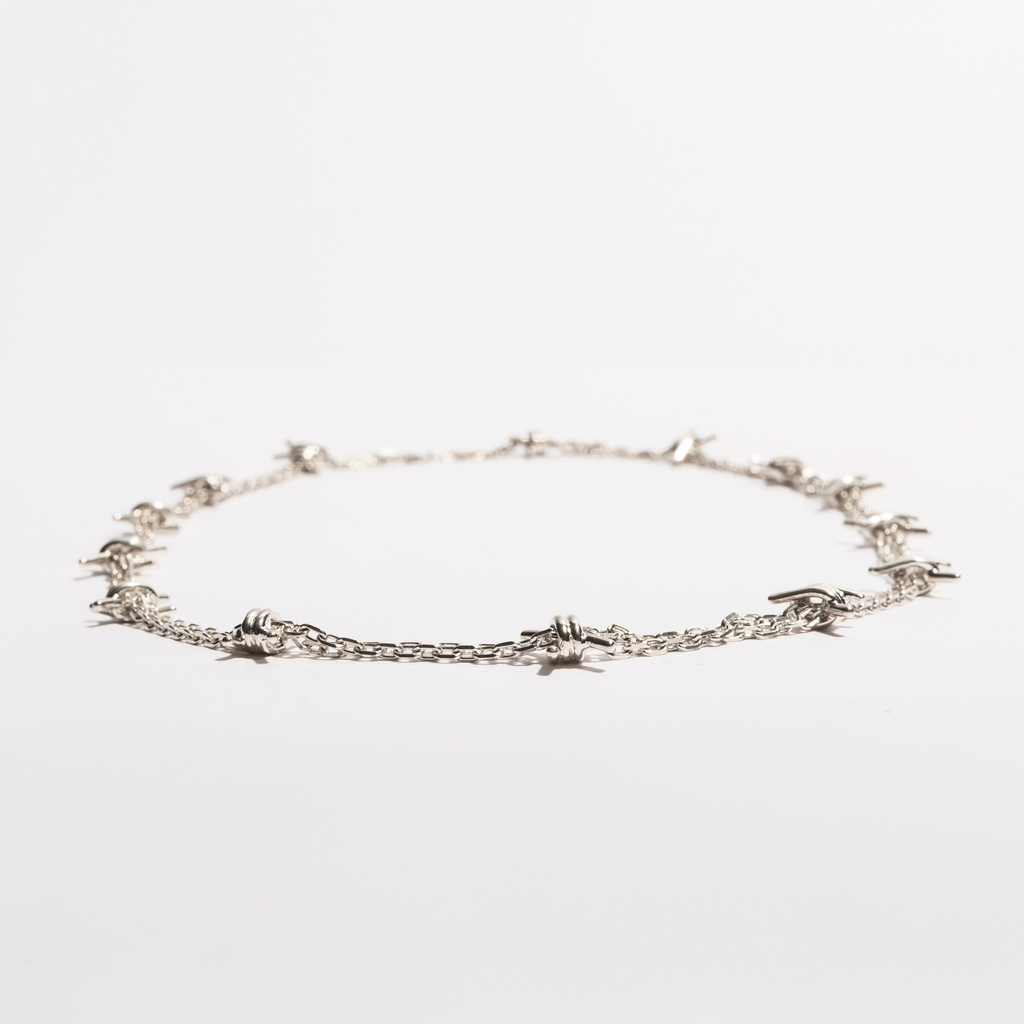 Flat view of the Barbwire Necklace by Sebamakes, sterling silver chain inspired by barbed wire and handcrafted in Italy.