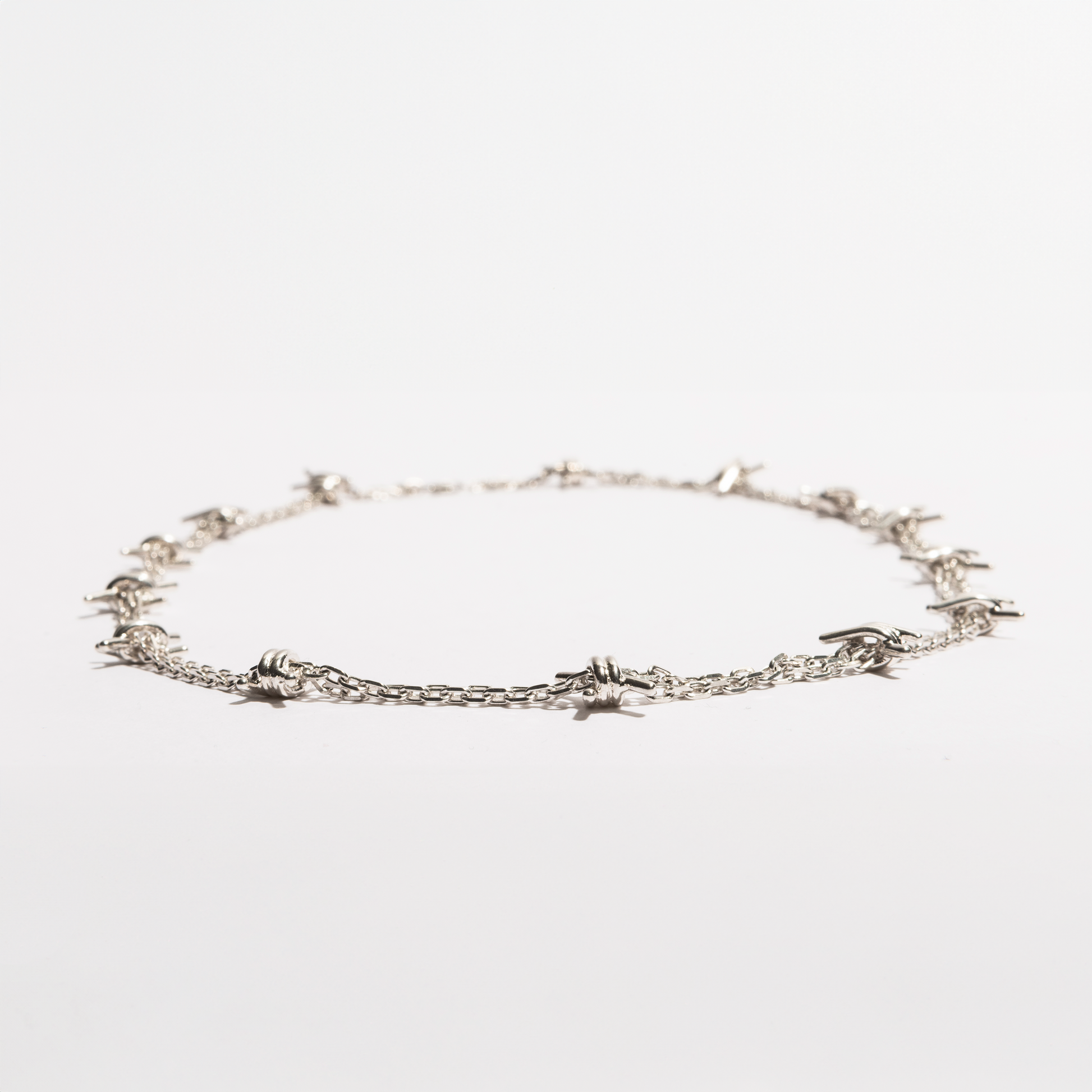 Flat view of the Barbwire Necklace by Sebamakes, sterling silver chain inspired by barbed wire and handcrafted in Italy.