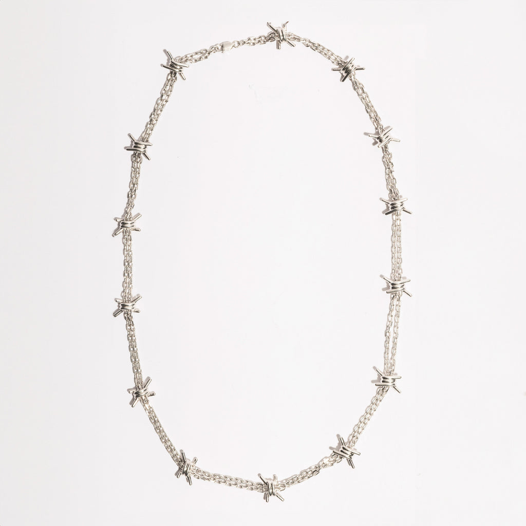 Full view of the Barbwire Necklace by Sebamakes, handcrafted sterling silver necklace inspired by barbed wire design, made in Italy.