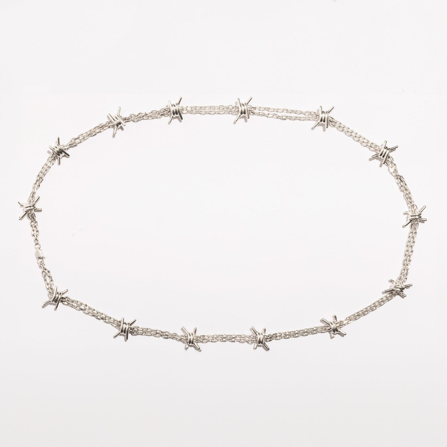 Full view of the Barbwire Necklace by Sebamakes, handcrafted sterling silver necklace inspired by barbed wire design, made in Italy.