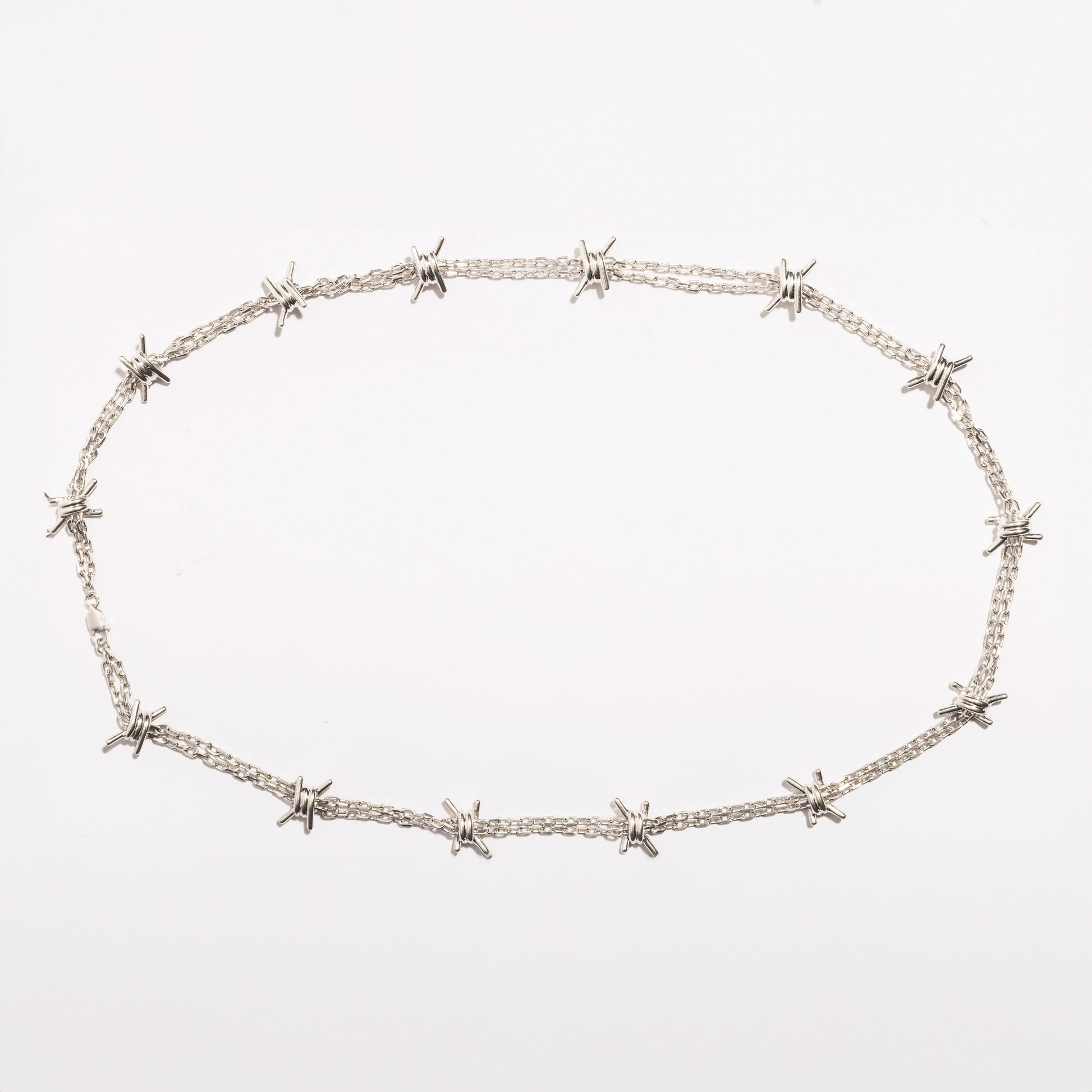 Full view of the Barbwire Necklace by Sebamakes, handcrafted sterling silver necklace inspired by barbed wire design, made in Italy.
