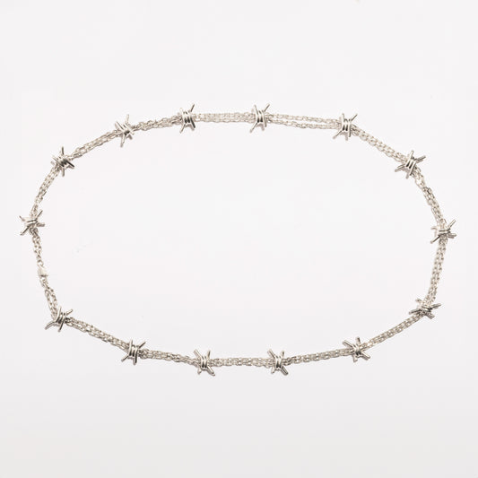 Full view of the Barbwire Necklace by Sebamakes, handcrafted sterling silver necklace inspired by barbed wire design, made in Italy.
