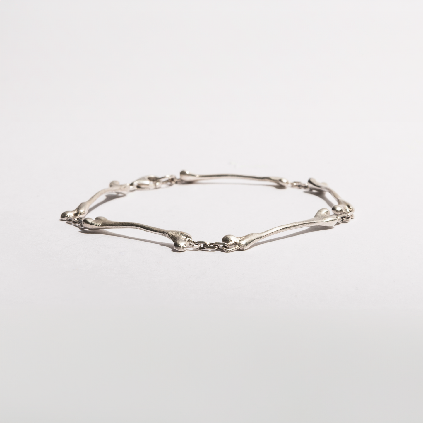 Angled view of the Bone Bracelet by Sebamakes, handcrafted in sterling silver with sculptural anatomical details and a minimal organic design.