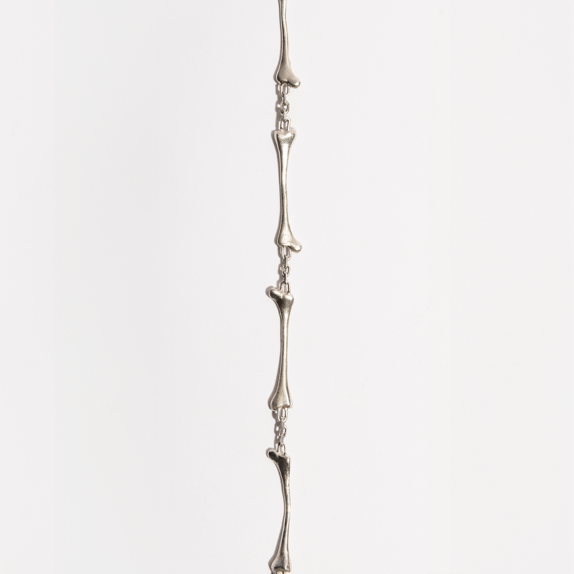 Close-up of the Bone Necklace showing detailed sterling silver bone-shaped link, handcrafted by Sebamakes in Italy.