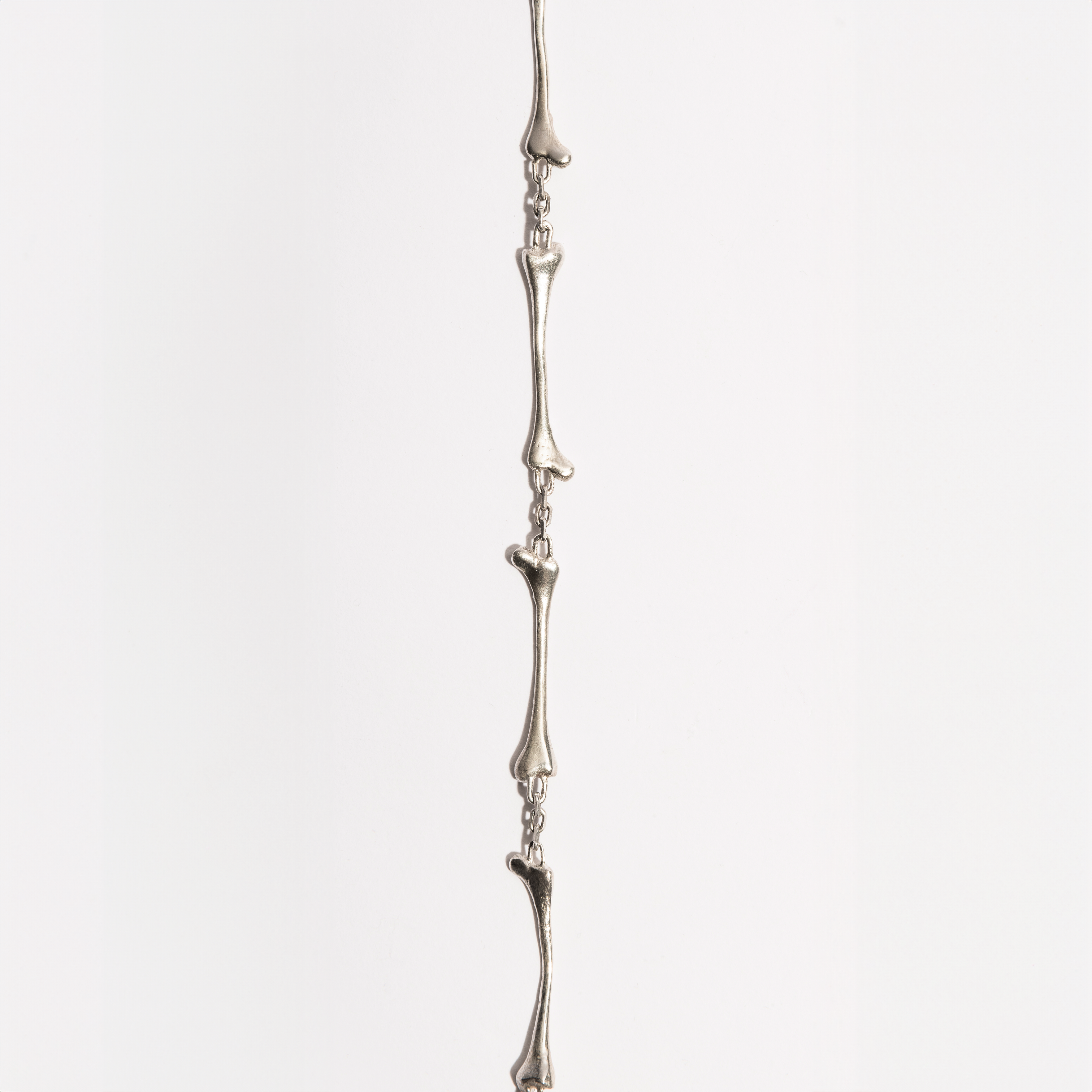Close-up of the Bone Necklace showing detailed sterling silver bone-shaped link, handcrafted by Sebamakes in Italy.