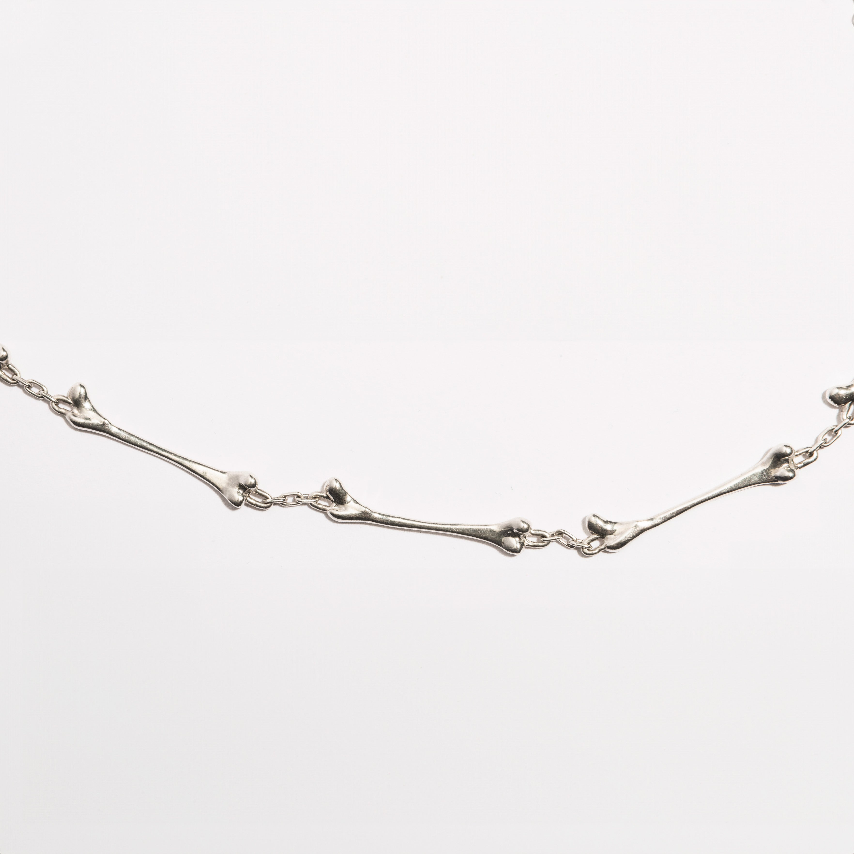 Detailed view of the Bone Necklace by Sebamakes, handcrafted sterling silver jewelry inspired by organic bone forms, made in Italy.
