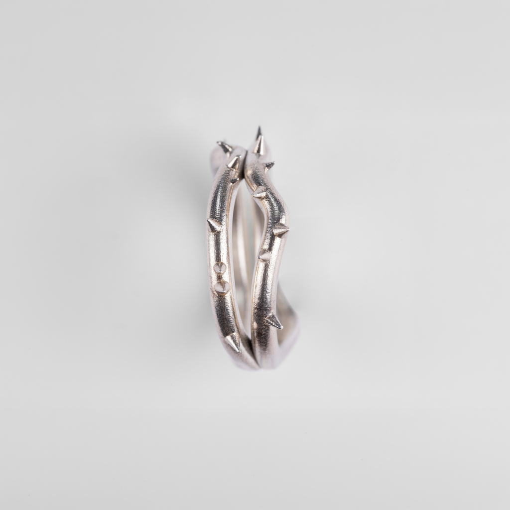 Side profile of the "Brambles" silver ring by Seba Makes, displaying the unique placement of the hand-modeled thorns along the band.