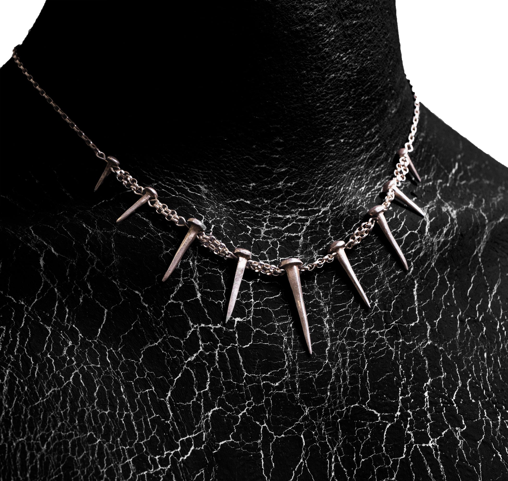 Close-up worn view of the Nails Necklace by Sebamakes, handcrafted sterling silver statement necklace inspired by industrial spikes and minimalist sculpture.