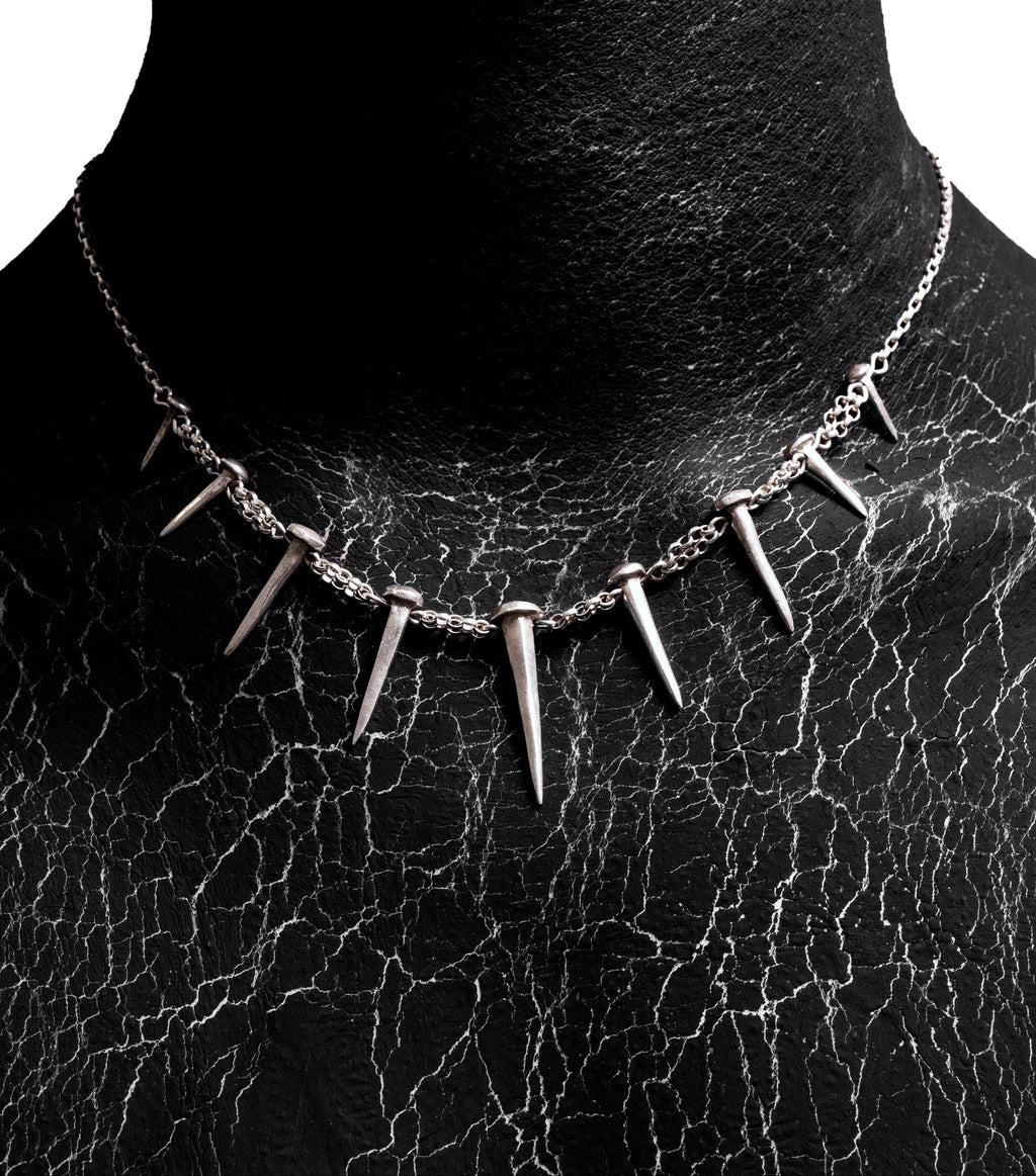 Front worn view of the Nails Necklace by Sebamakes, handcrafted sterling silver necklace featuring nail-shaped spikes and bold sculptural design, made in Italy.
