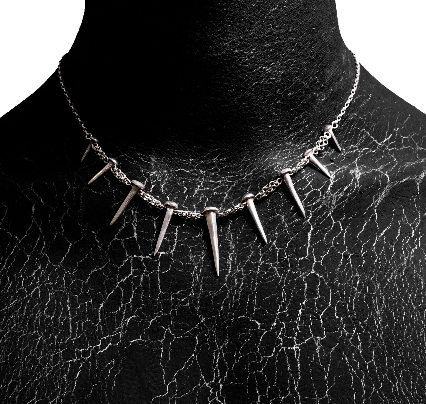 Front worn view of the Nails Necklace by Sebamakes, handcrafted sterling silver necklace featuring nail-shaped spikes and bold sculptural design, made in Italy.