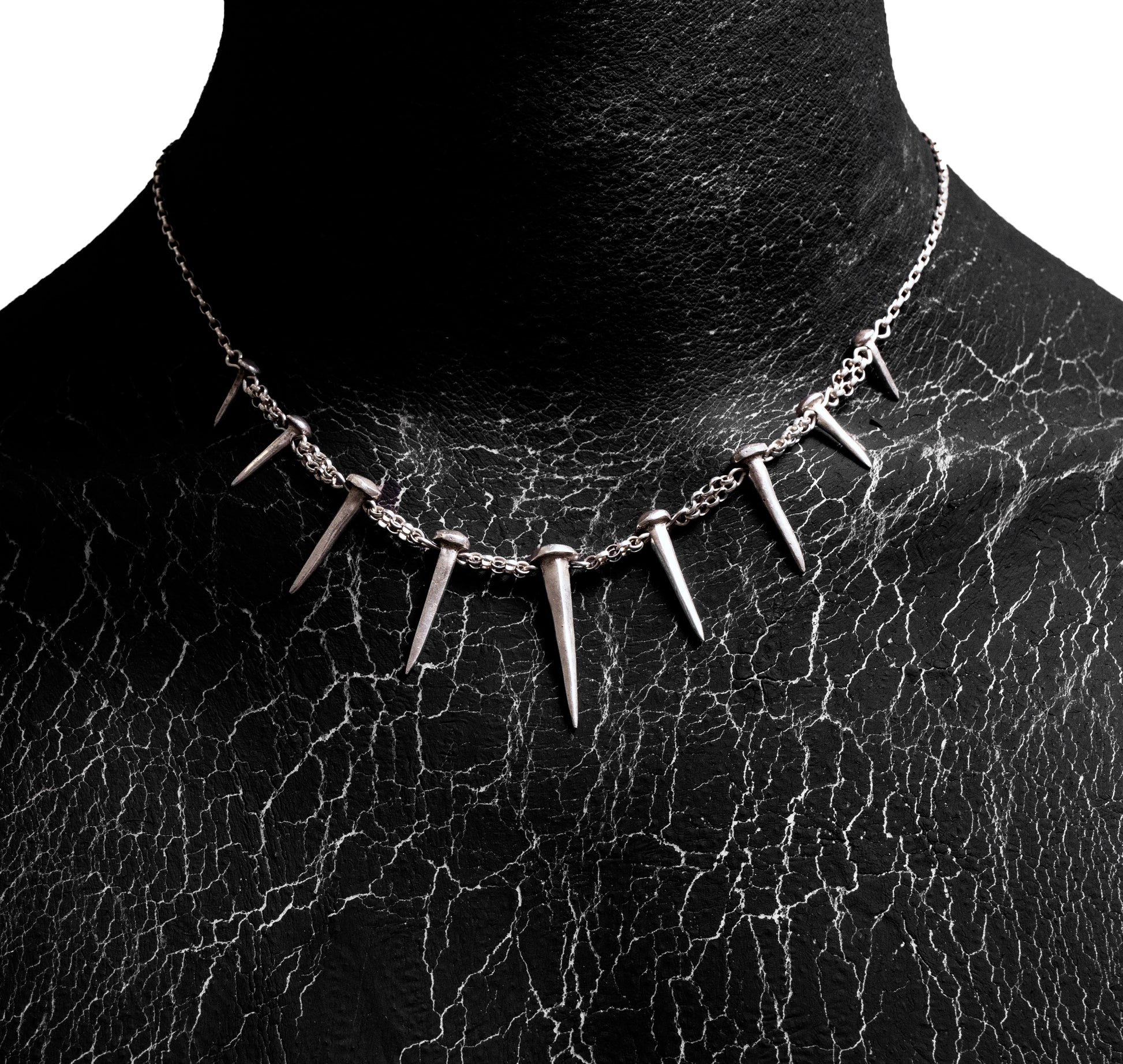 Front worn view of the Nails Necklace by Sebamakes, handcrafted sterling silver necklace featuring nail-shaped spikes and bold sculptural design, made in Italy.