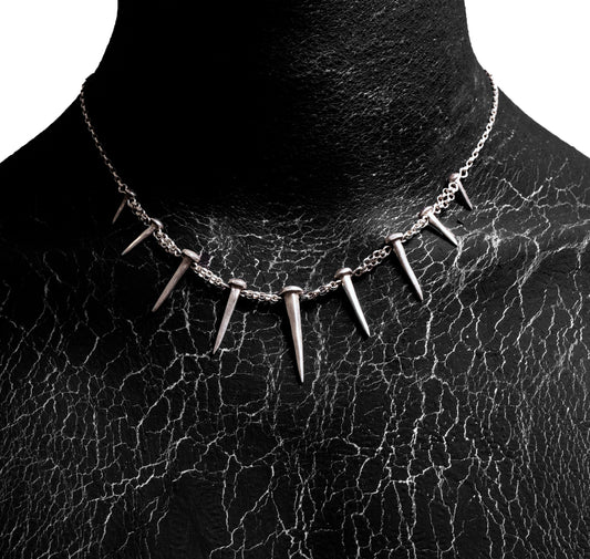 Front worn view of the Nails Necklace by Sebamakes, handcrafted sterling silver necklace featuring nail-shaped spikes and bold sculptural design, made in Italy.
