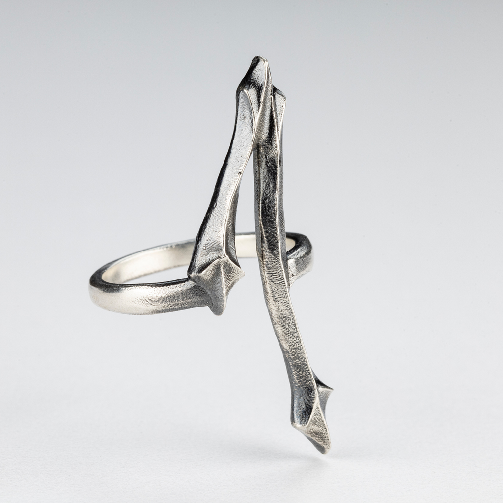 Detail view of the One Ring showing its handcrafted gothic and brutalist silver structure