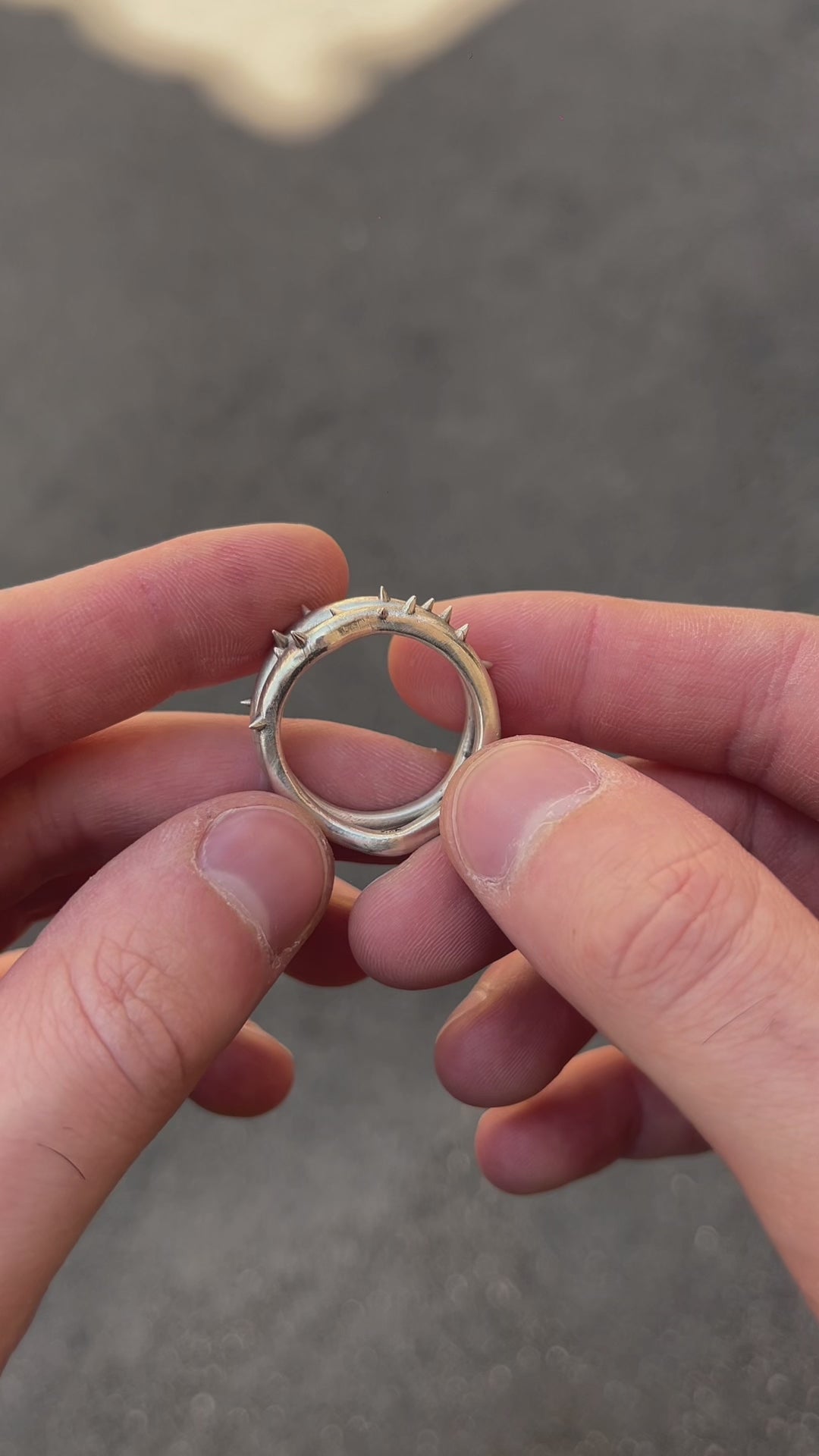 Demonstration video of the "Brambles" silver ring held in hands, revealing the 3D sculptural thorns and organic branch texture crafted by Seba Makes.