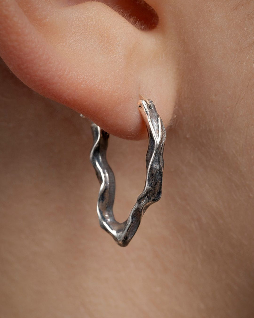 Short Ridge hoop earrings worn on the earlobe, showcasing the fit and shape.
