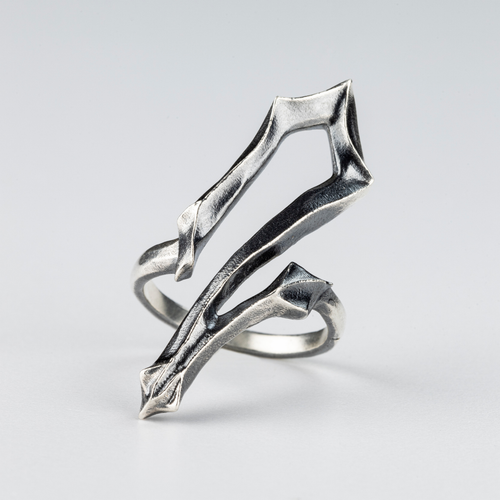 Angled shot of the 2 Ring displaying sharp gothic lines and oxidized finish