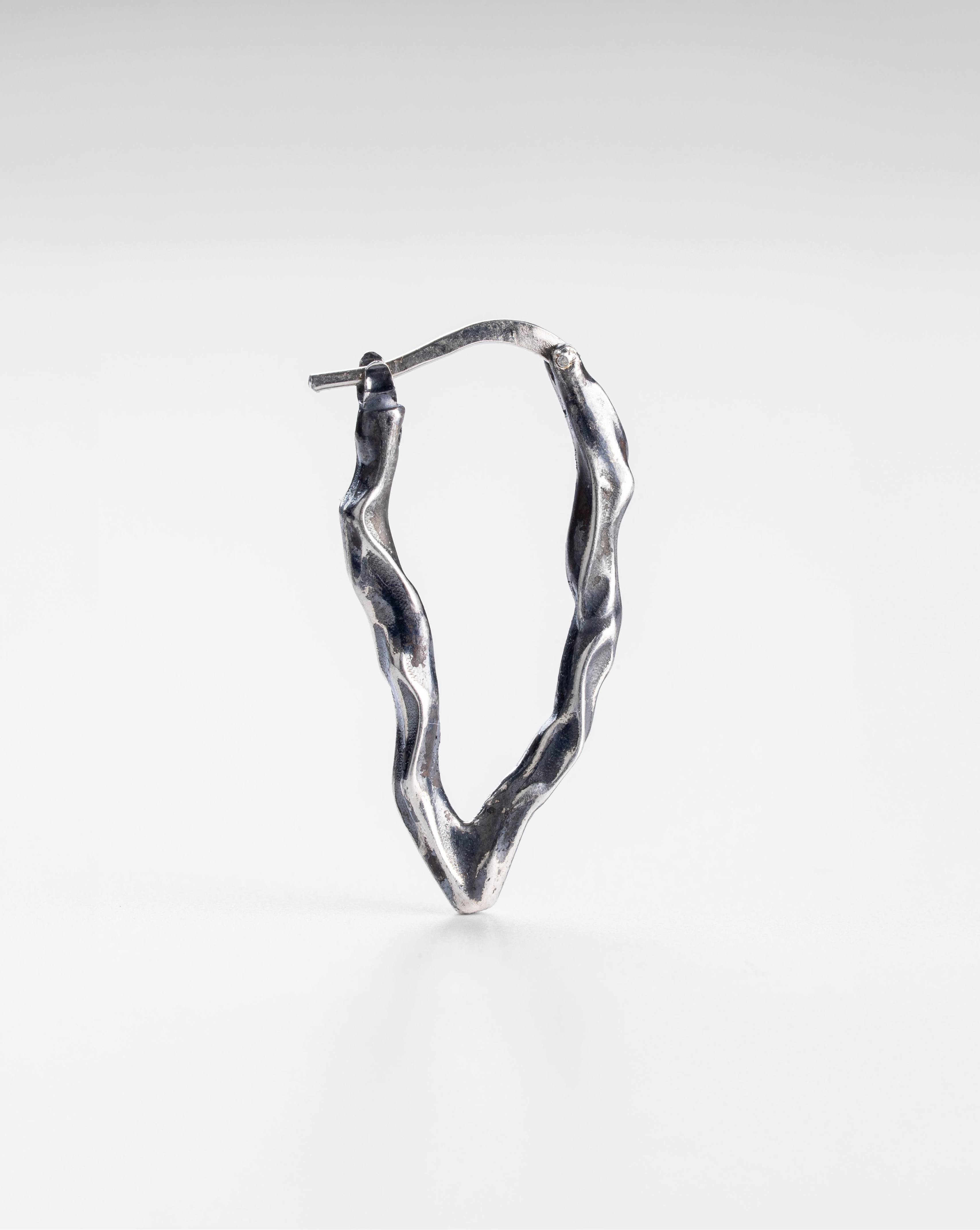 Oxidized 925 sterling silver long Ridge drop earrings, close-up view of the elongated handmade design.