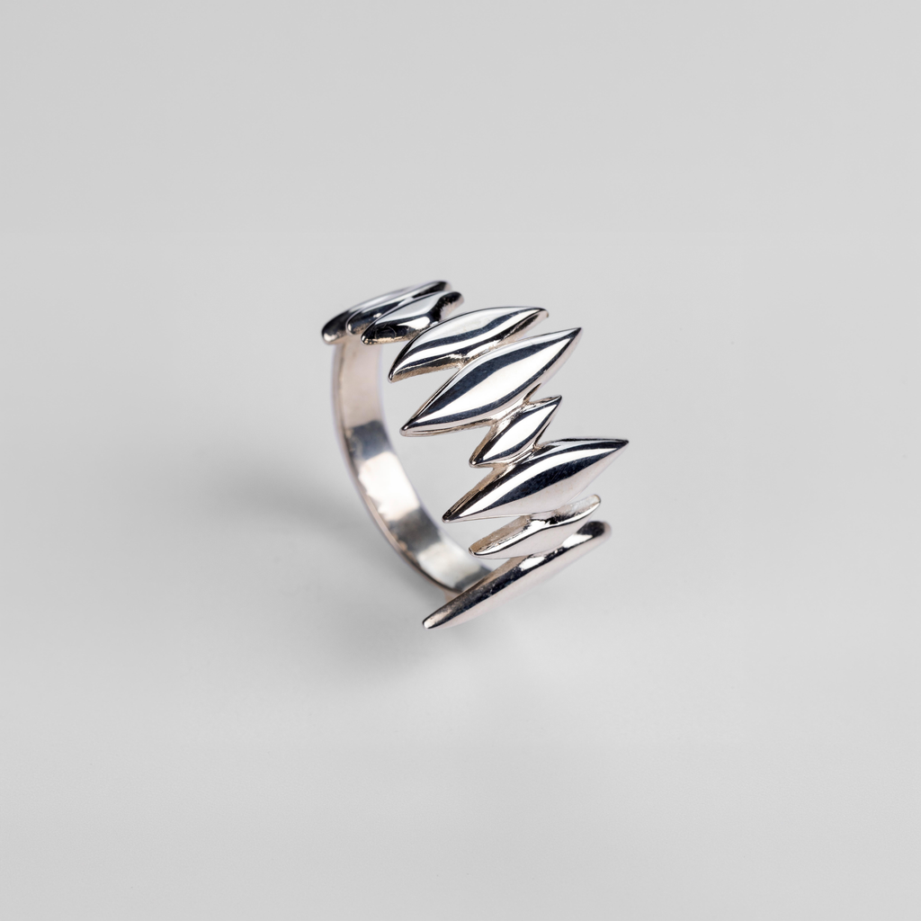 Angle view of the handmade sterling silver Splinter Ring on a neutral background.