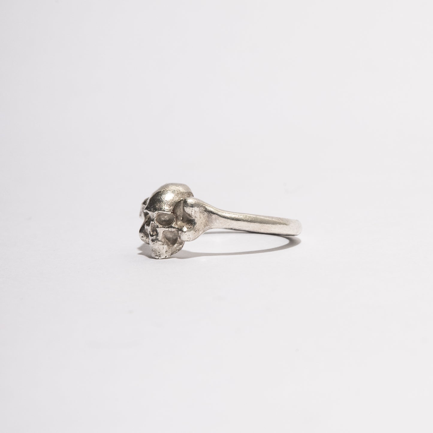 Side view of the Silver Skull Ring in sterling silver, handcrafted gothic jewelry by Sebamakes with detailed skull design.