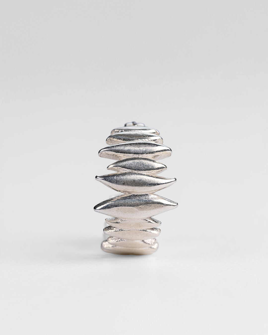 Handcrafted silver Splinters hoop earrings, angled perspective of the jagged texture.