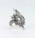 Silver ring with an organic textured design and central opening, angled view handcrafted by sebamakes
